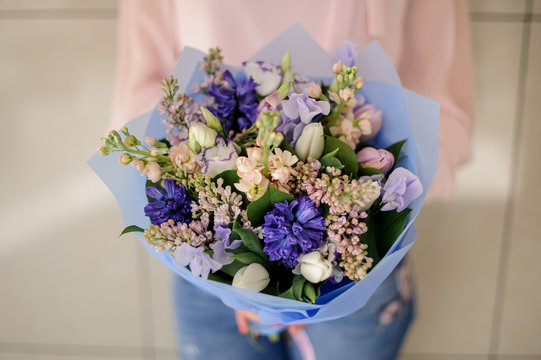 Florist woman holding a beautiful fresh blossoming bouquet