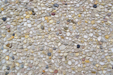 Grey stone material decored on cement wall. Closeup of gray texture background.