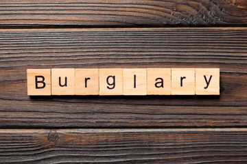 burglary word written on wood block. burglary text on table, concept