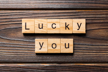 Lucky you word written on wood block. Lucky you text on wooden table for your desing, Top view concept