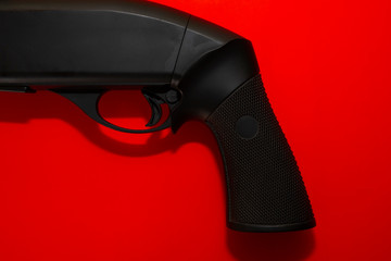 Black shotgun on a red background.