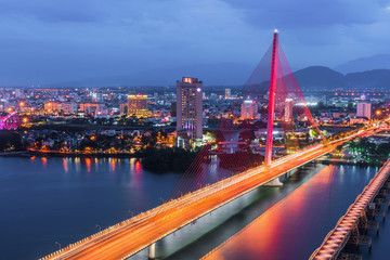 Han River Bridge (Cau Song Han) over the Han River in Da Nang, central Vietnam. Da Nang skyline cityscape by twilight period