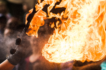 Fire show artist breathe fire in the dark jamp.