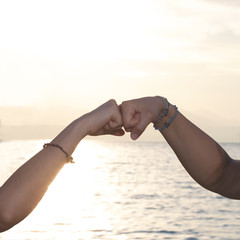 punch against punch, gesture of friendship of two girls