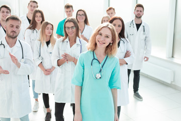 Fototapeta premium rear view. casual young woman standing in front of a white wall.