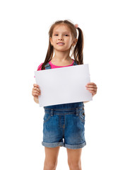 Fototapeta premium Happy cute child holding empty blank isolated on white background. kid with placard board for your text. girl with white sheet of paper. copy space