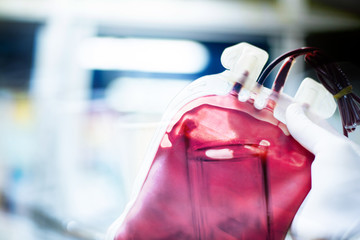 Double exposure red blood bag with test tube in laboratory.