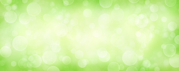 Fototapeta na wymiar Spring background with green blurred bokeh lights.