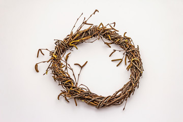 Fototapeta premium Wicker wreath of birch branches isolated on white background. Easter zero waste, DIY concept. Design element and decor