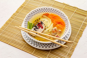 Korean noodle soup with smoked chicken and vegetables. Spicy dish for healthy meal
