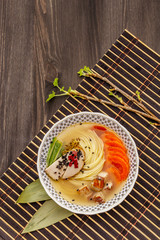 Korean noodle soup with smoked chicken and vegetables. Hot spicy dish for healthy meal