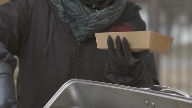 Close up of cook seller giving street food to customer at food truck