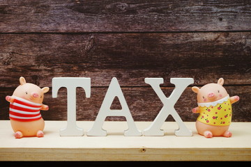 Time to pay TAX concept tax alphabet letters on wooden background