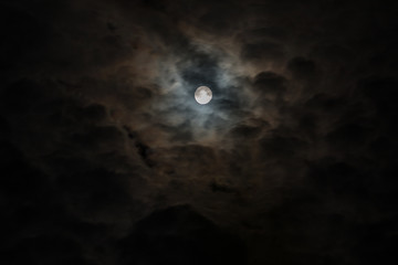 Obraz na płótnie Canvas Moon in dark clouds