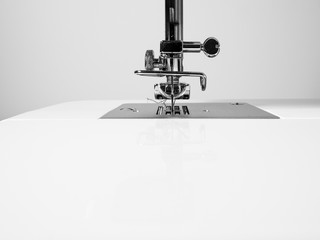Sewing machine detail on a white wall background