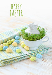 Happy Easter. Easter banny in Cup and decor eggs. festive table composition. spring season. 