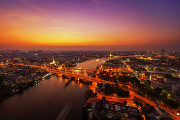 Fototapeta na wymiar City Scape, Panorama of Chao Praya River. River view overlooking the Phra Phuttha Yodfa Bridge or Memorial Bridge and Wat Arun with grand Palace in the background, Bangkok Thailand. 26 January 2019