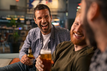 Friends enjoying beer at pub