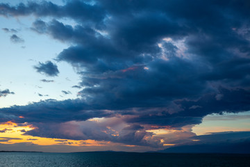 Naklejka na ściany i meble Dark clouds over the Adriatic Sea in sunset