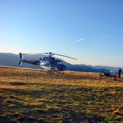 Pilot supply the helicopter on the mountain