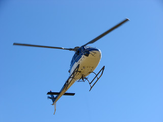 Naklejka na ściany i meble Helicopter isolated on blue background