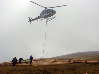 Fototapeta na wymiar Helicopter transport a wood beam