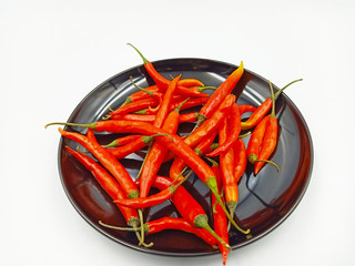groups of Red chili peppers on black plate 
