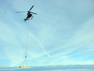 Helicopter transports a sawn timber