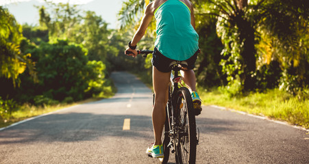 Cyclist cycling mountain bike on tropical forest trail