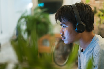 Close-up of a man listening music on headphone