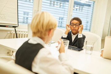 Children as business people conduct negotiations
