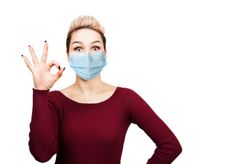 young woman sign ok, wearing protective face mask prevent virus infection, pollution, white isolated background