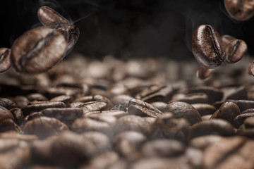 roasted coffee close-up on a dark background of other coffee beans