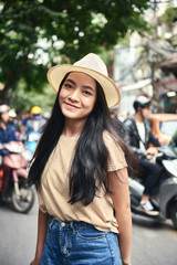 Portrait of young Vietnamese woman in the city