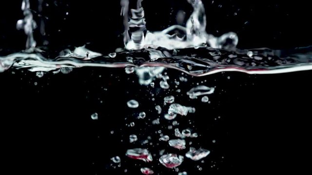 raspberry falling into water- raspberry splashing into water, slow motion