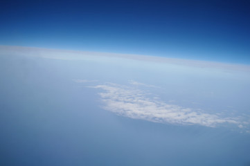 Naklejka na ściany i meble clouds and blue sky seen from plane