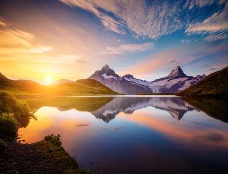 Magnificent panorama of the alpine lake Bachalpsee at dawn. Location Swiss alps, resort Grindelwald,