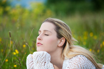 young lady brething in fresh air in field