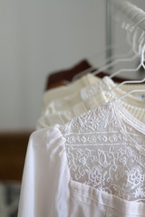 Fototapeta na wymiar Capsule wardrobe in white and neutral tones. Selective focus.
