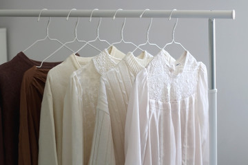 Capsule wardrobe in white and neutral tones. Selective focus.