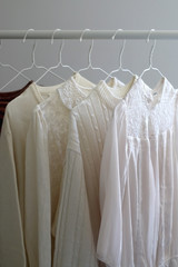 Capsule wardrobe in white and neutral tones. Selective focus.