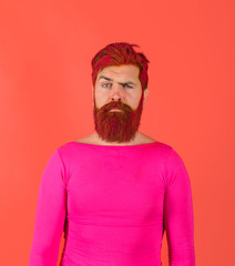 Bearded man with colored hair. Serious man with dyed beard and hair. Hipster with pink hair. Hairstyle. Hairstylist. Advertising and barber shop concept. Man with creative painting hair and hairstyle.