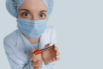 Nurse with blood sample looks at you fearfully. Concept of coronavirus quarantine, MERS Wuhan,...