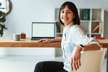 Beautiful girl smiling at camera in office