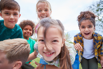Portrait Of Children On Outdoor Activity Camping Trip Having Fun Playing Game Together