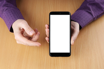 Man sitting at a table shows the viewer the screen of his smartphone