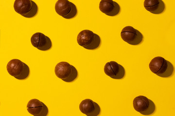 Macadamia nut pattern on yellow paper background