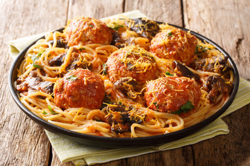  recipe for delicious spaghetti served with meatballs and mushroom gravy closeup in a plate. horizontal