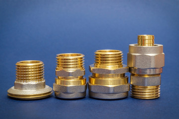 Four brass fittings is often used to connect for water and gas installations on blue background