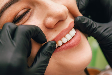 dentist examines teeth patient girl, close up